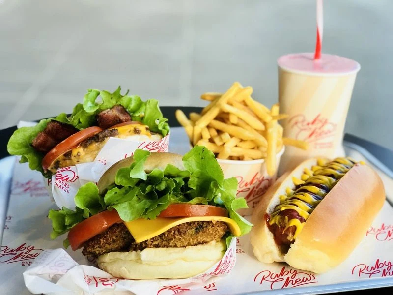 Ruby Chews burgers with golden fries and a hot dog