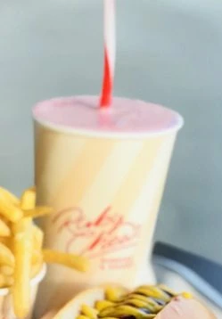 A pink Ruby Chews frozen custard shake in a branded cup